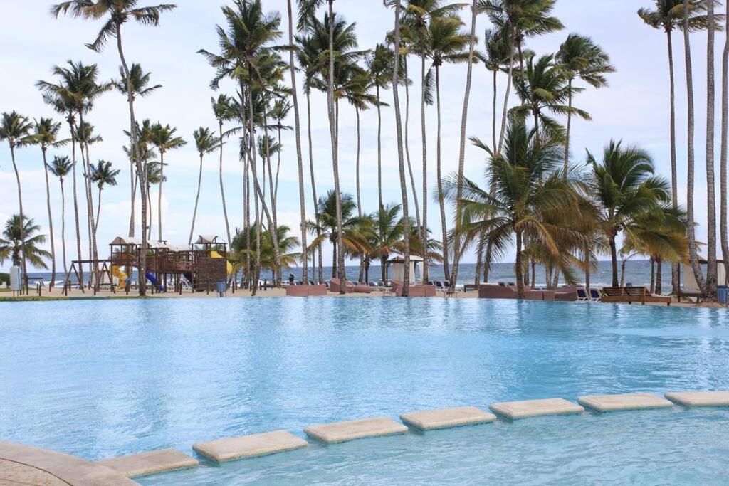a swimming pool with palm trees and a playground at Marbella AquaVista 11-18 in Juan Pedro