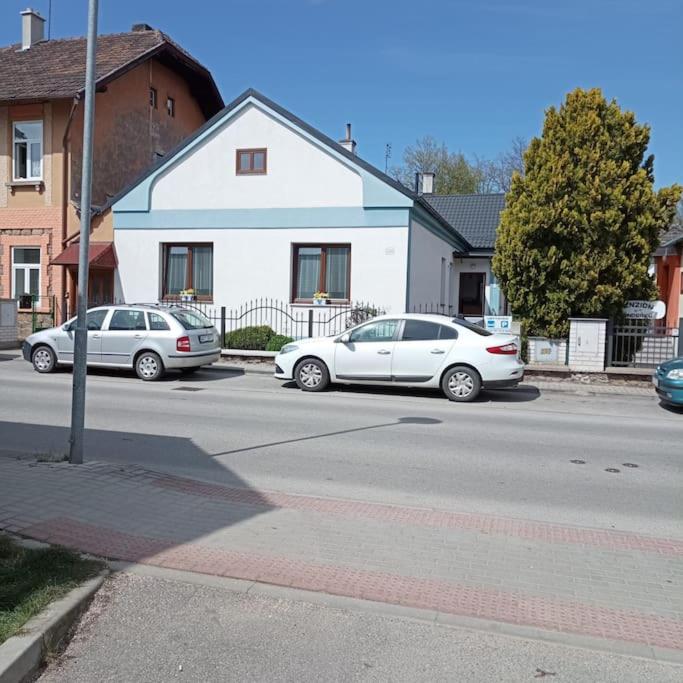 three cars parked in a parking lot next to a house at U Melicherů in Suchdol nad Lužnicí