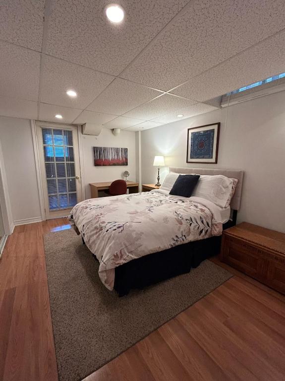 a bedroom with a large bed and a window at Maya Bed and Breakfast in Port Perry