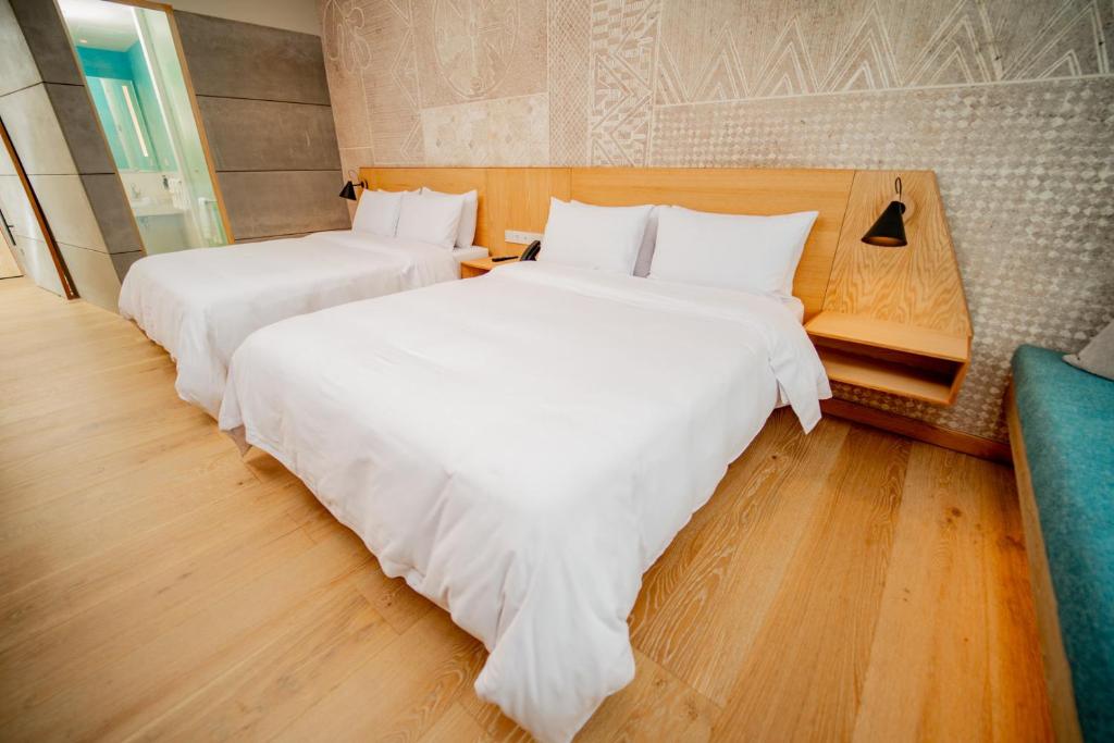 Postel nebo postele na pokoji v ubytování GO Quito Hotel