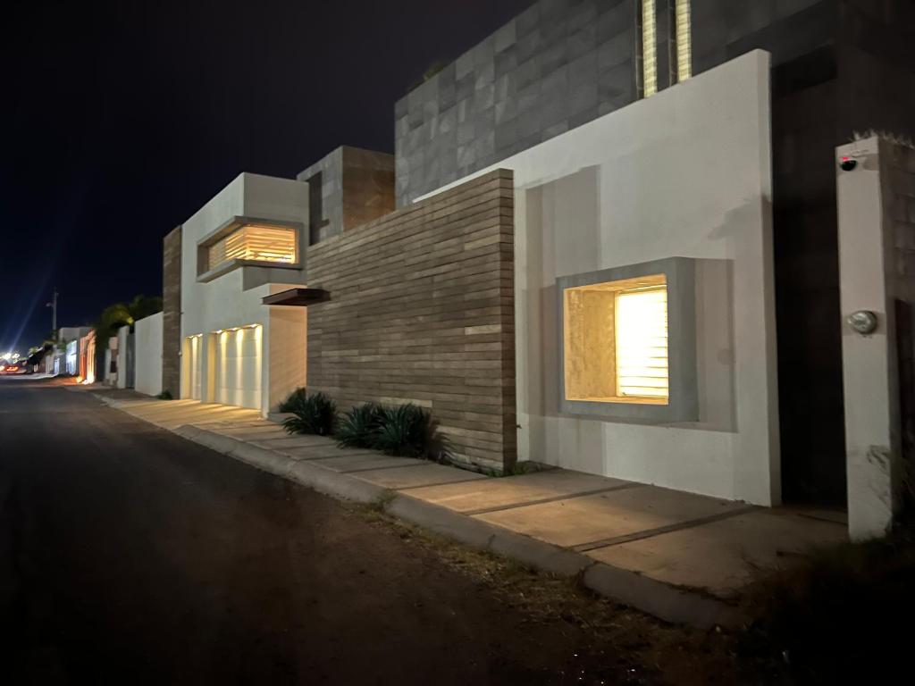 a building on the side of a street at night at Casa Concept Delicias in Delicias