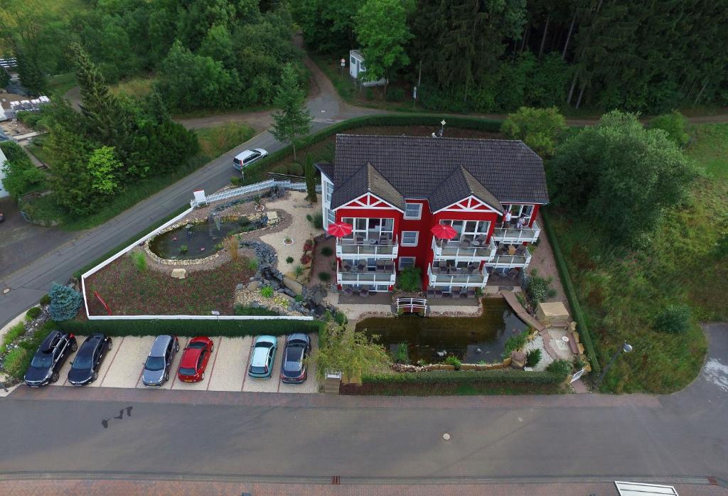 an aerial view of a house with cars parked in a parking lot at Maarberg Resort in Schalkenmehren