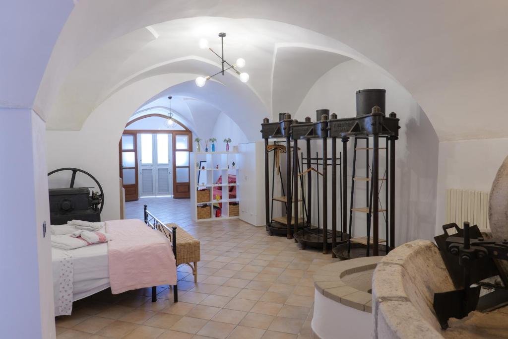 a room with a bed and a table in it at FRANTOIO NONNA VALERIA in Diso