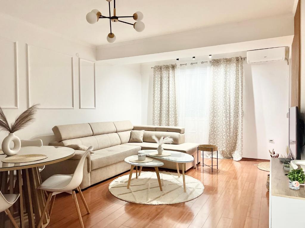 a white living room with a couch and tables at PREMIER Luxury Apartments in Strumica