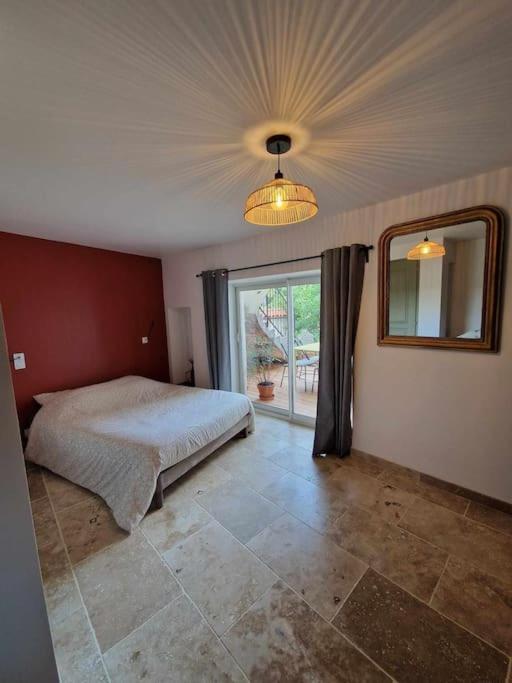 une chambre avec un lit et une grande fenêtre dans l'établissement Logement privé avec terrasse, à Chanonat