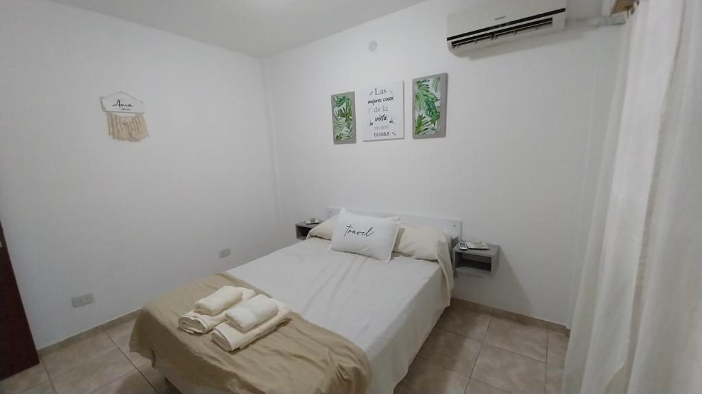 En eller flere senge i et værelse på Departamento Marusa