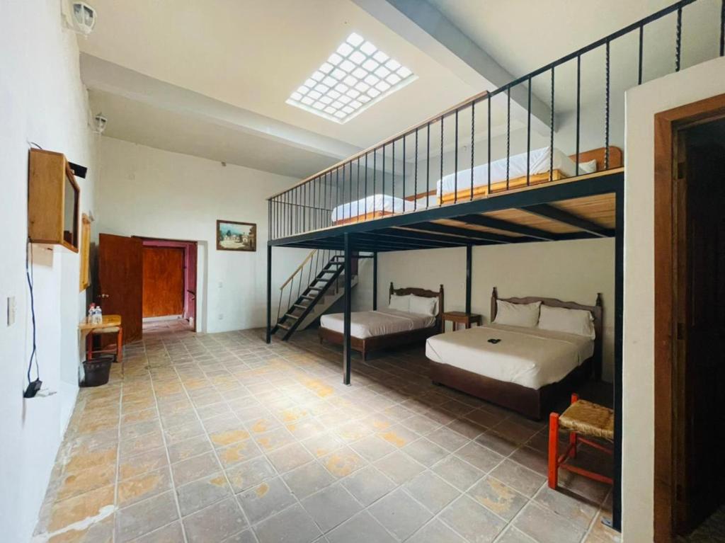Postel nebo postele na pokoji v ubytování HOTEL EX HACIENDA EL MOLINO