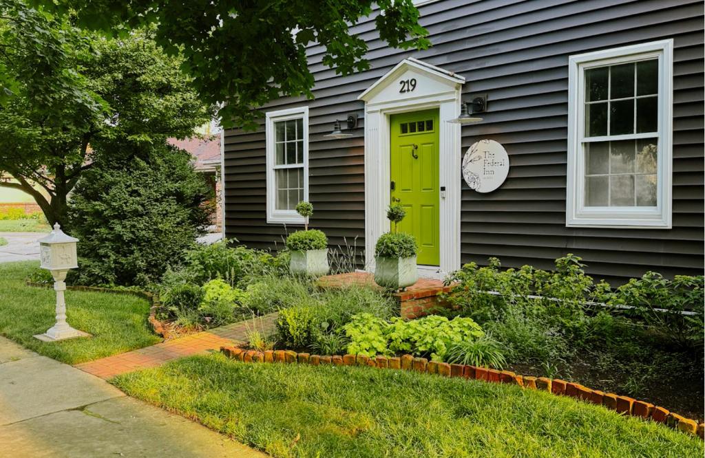 a house with a green door in the yard at The Federal Inn in Maumee