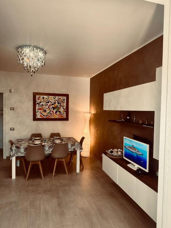 a dining room with a table and a television at Casa Regina in Civitanova Marche