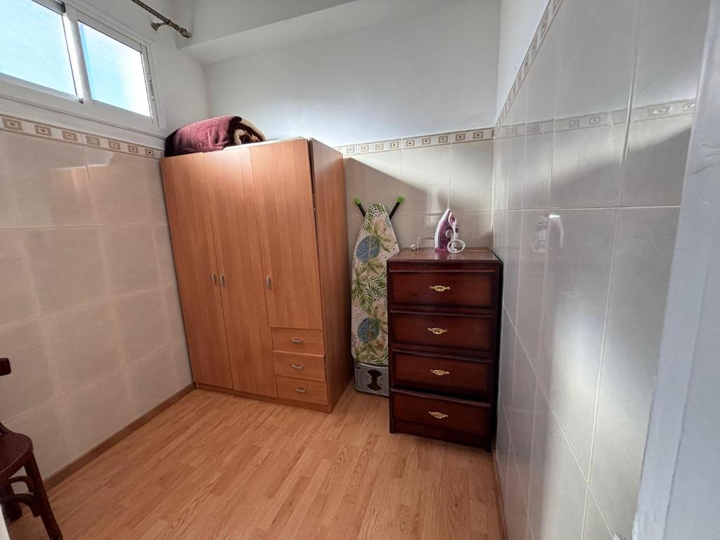 a bedroom with a cabinet and a dresser in a room at Piso Centrico in Tangier