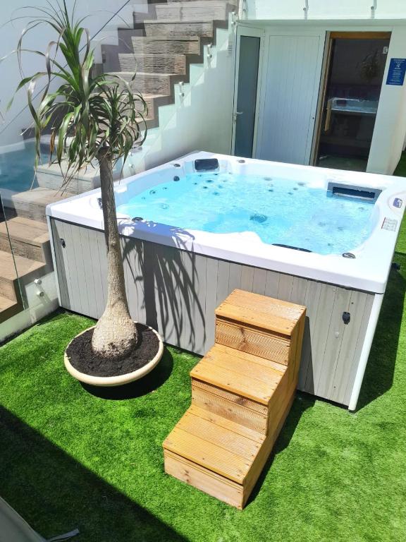 a large plunge pool with a palm tree and stairs at Casa de Moledo Beach, Spa & Sauna in Moledo