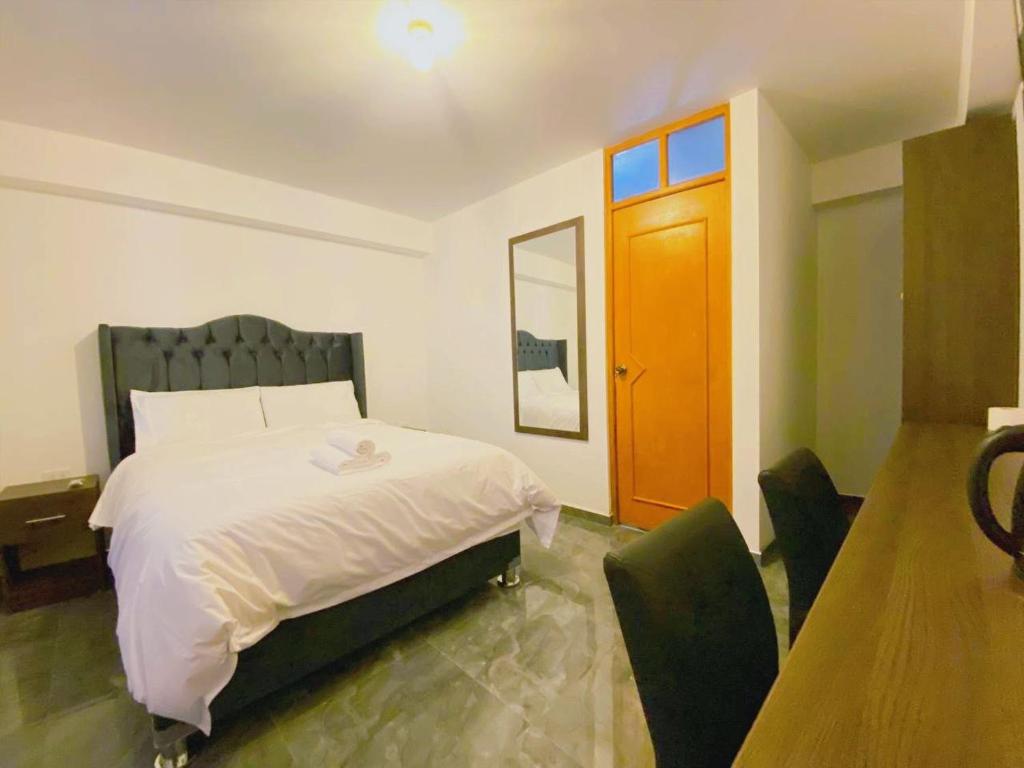 Postel nebo postele na pokoji v ubytování Huaraz Essences Hotel