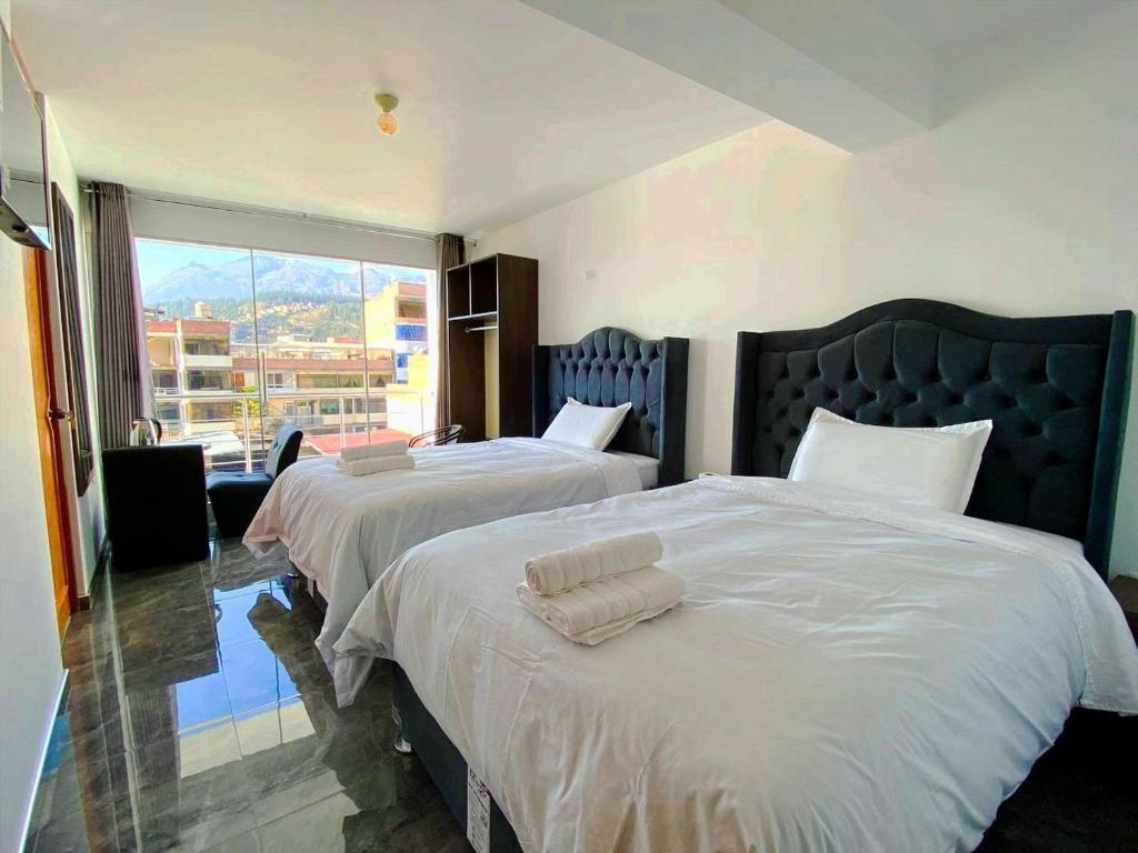 Postel nebo postele na pokoji v ubytování Huaraz Essences Hotel