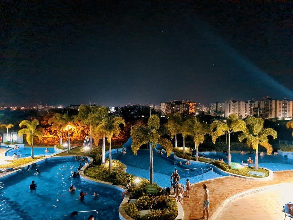 a large swimming pool with people in it at night at Alta Vista Thermas Resort in Caldas Novas