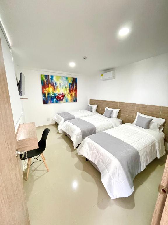 Letto o letti in una camera di Hotel Olam Deluxe Valledupar