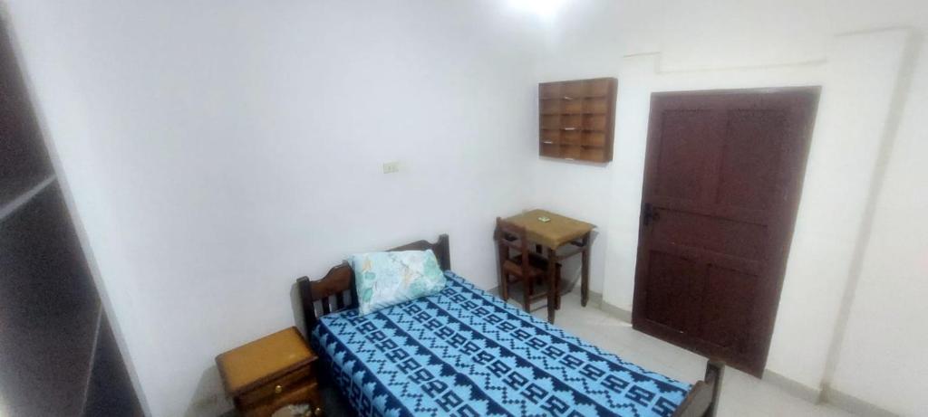 a small room with a bed and a door at Casa Dorado - Vallegrande in Vallegrande