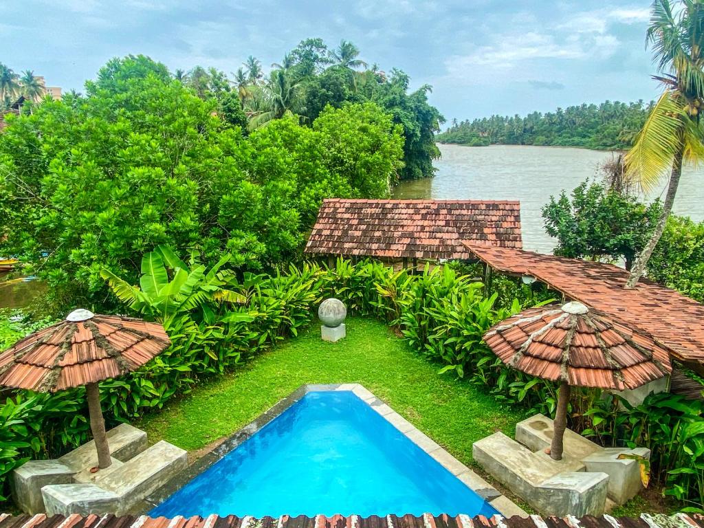 an aerial view of a resort with a swimming pool and umbrellas at Waterland in Negombo