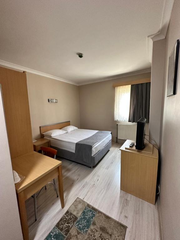 A bed or beds in a room at OTEL AMİLLER