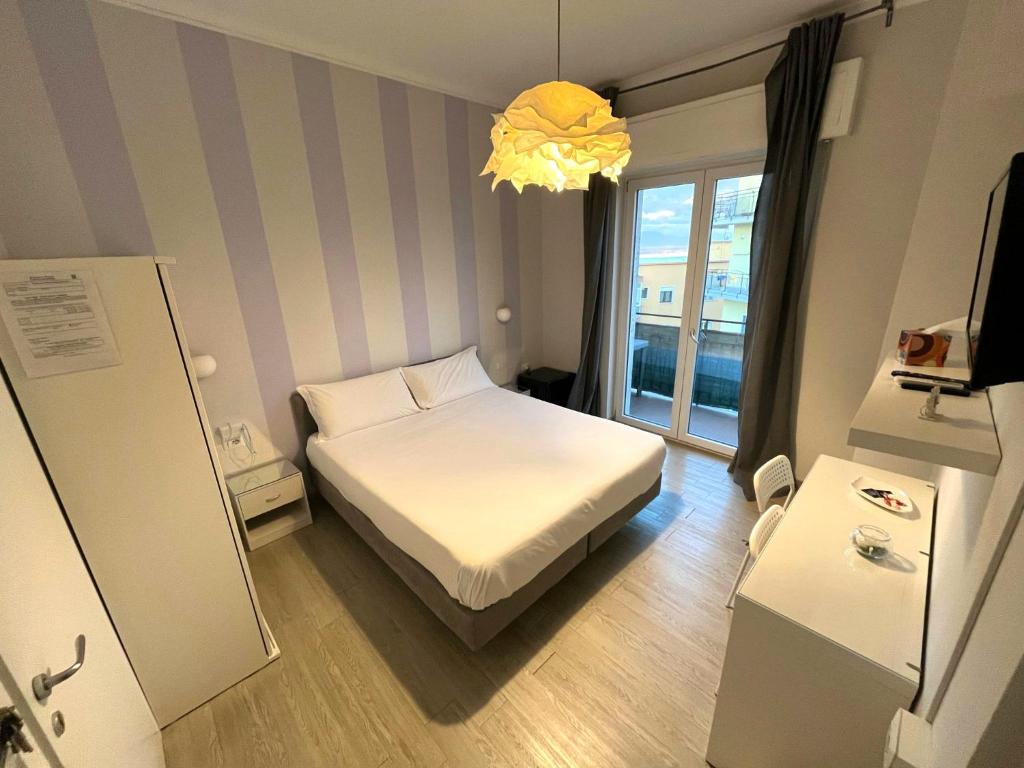 a small bedroom with a bed and a window at F.Rooms Napoli in Naples