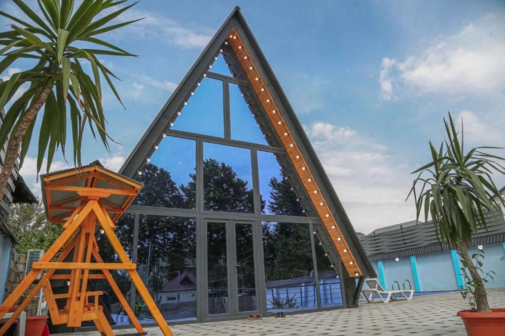 un grande specchio davanti a un edificio con alberi di A-Frame Villa in Gabala with Garden & FREE Airport shuttle a Gabala