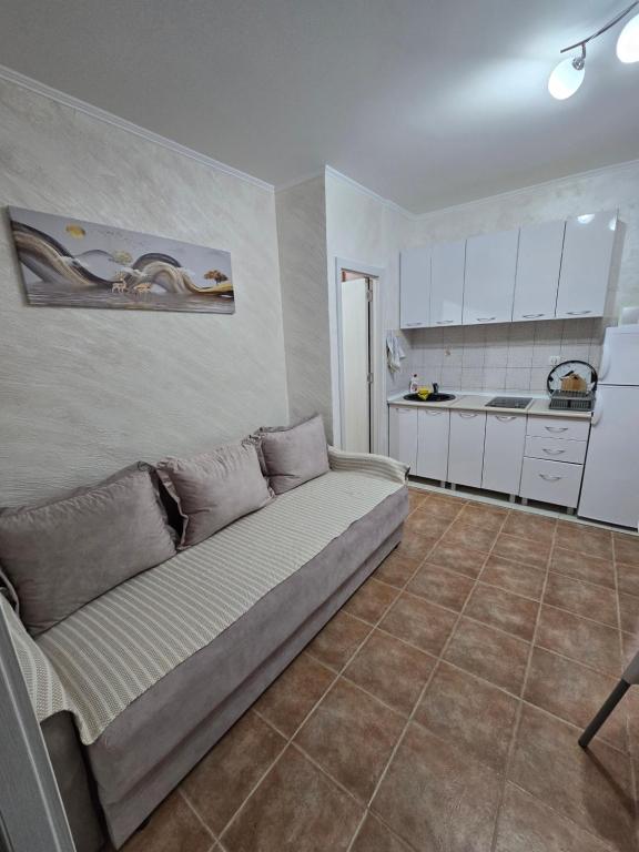 a living room with a couch and a kitchen at Apartman Turkovic in Herceg-Novi