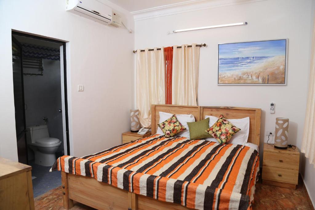 Postel nebo postele na pokoji v ubytování Villa Baywalk Goa - 200 meters from Morjim Beach