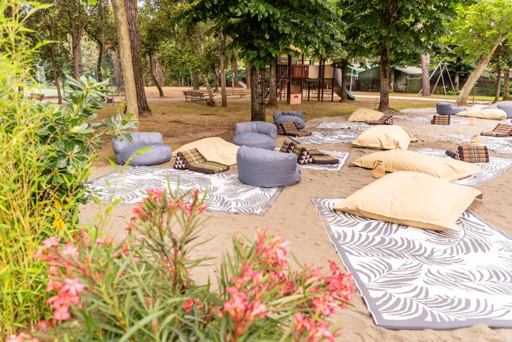 a group of pillows sitting on the sand in a park at Club del Sole Viareggio Family Collection in Torre del Lago Puccini