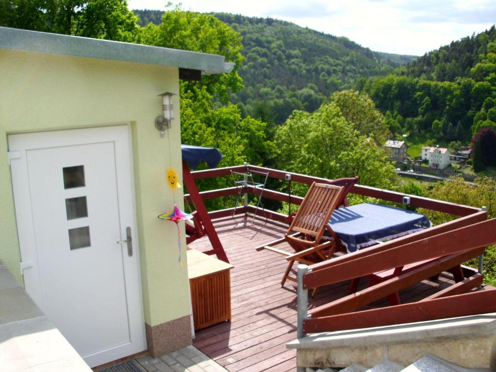 a balcony with two chairs and a door with a view at Haus-Panoramablick in Königstein an der Elbe