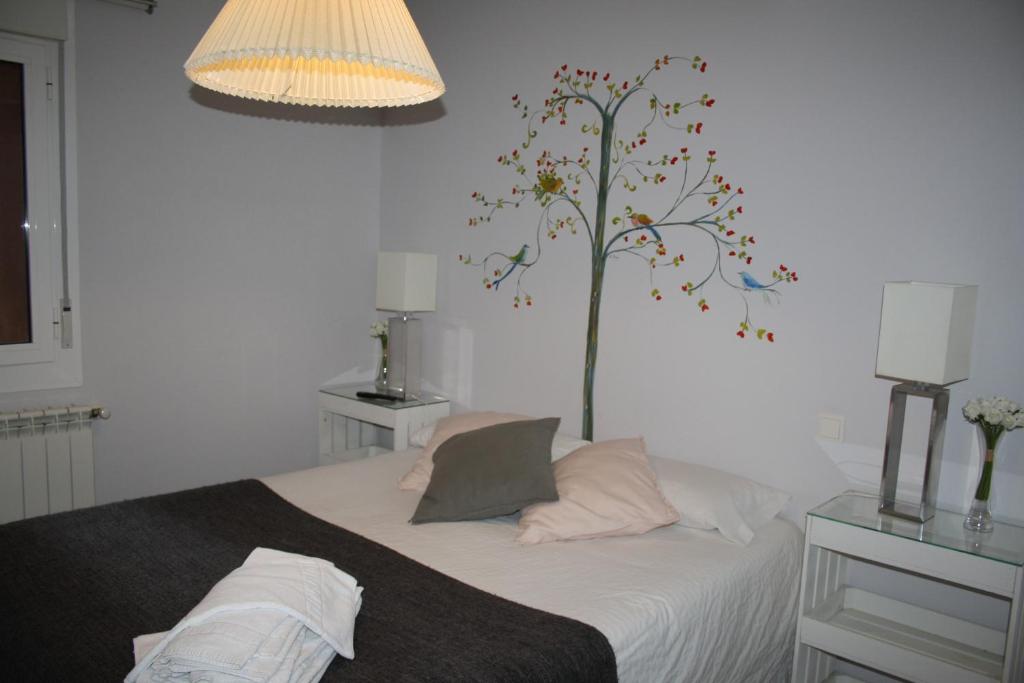 Postel nebo postele na pokoji v ubytování Apartamentos "Casa Abuelo Juan"