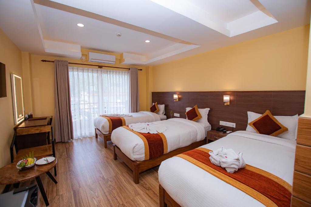 A bed or beds in a room at Hotel Hidden Kingdom