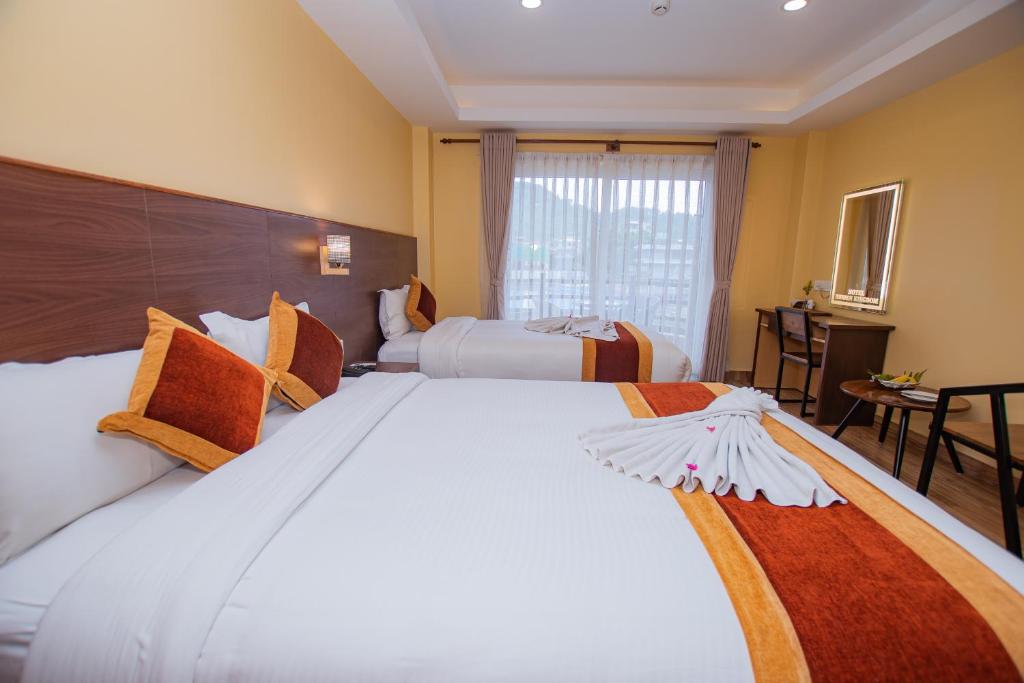 A bed or beds in a room at Hotel Hidden Kingdom