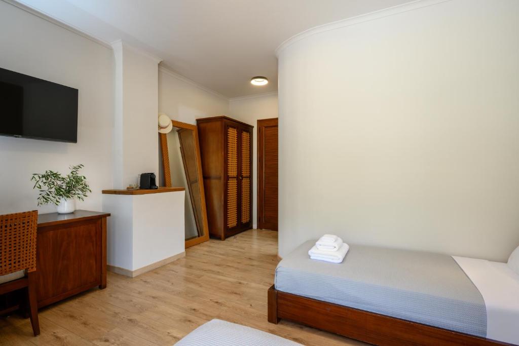 Postel nebo postele na pokoji v ubytování Elisso Hotel