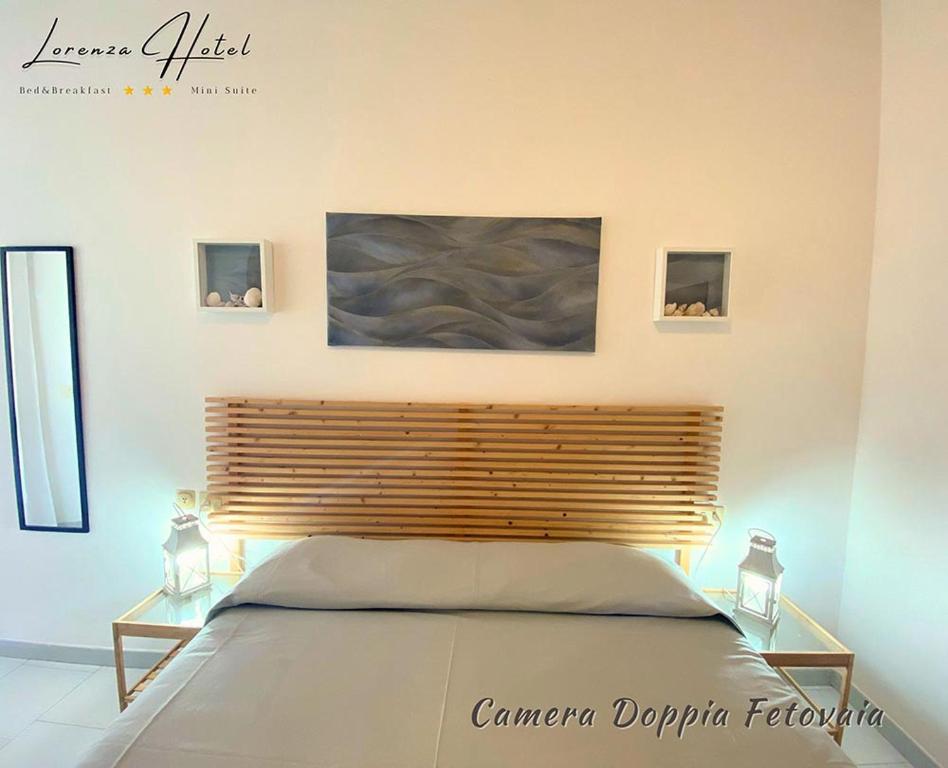 Postel nebo postele na pokoji v ubytování Hotel Lorenza B&B e Mini Suite