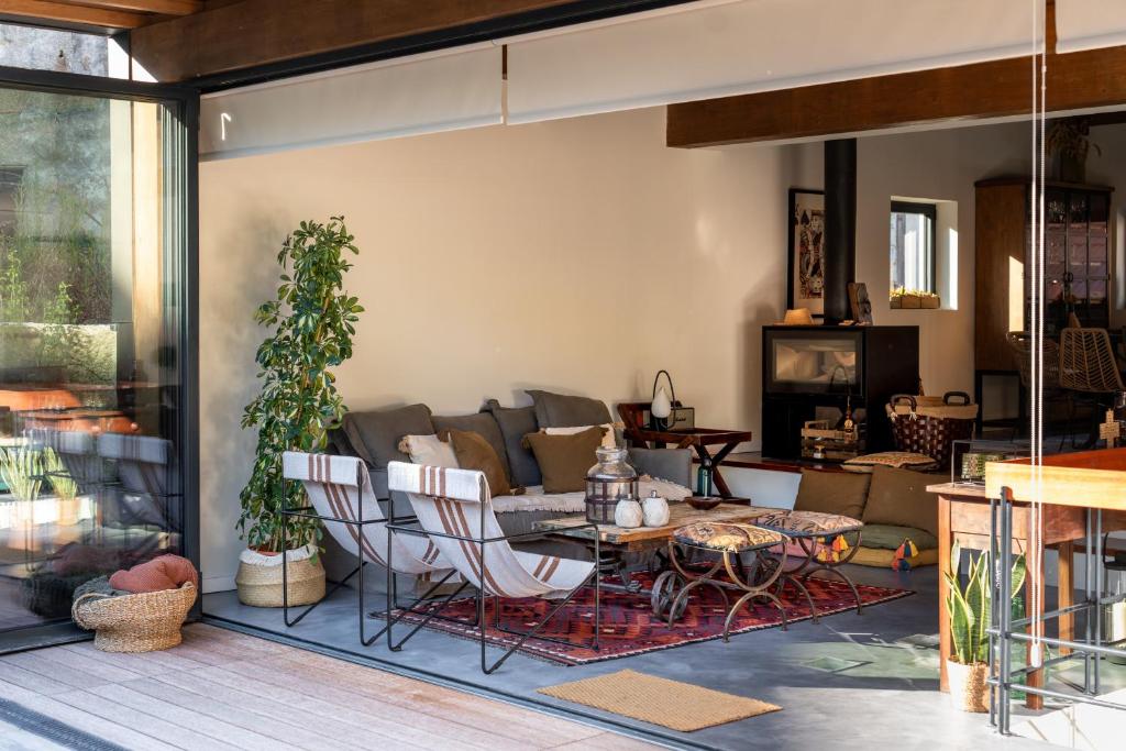 a living room with a couch and a table and chairs at Feel Discovery P&P House Douro Valley in Resende