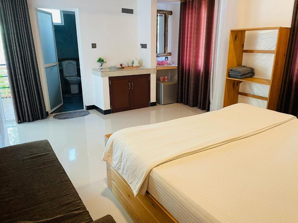Postel nebo postele na pokoji v ubytování Dhanudi Homestay
