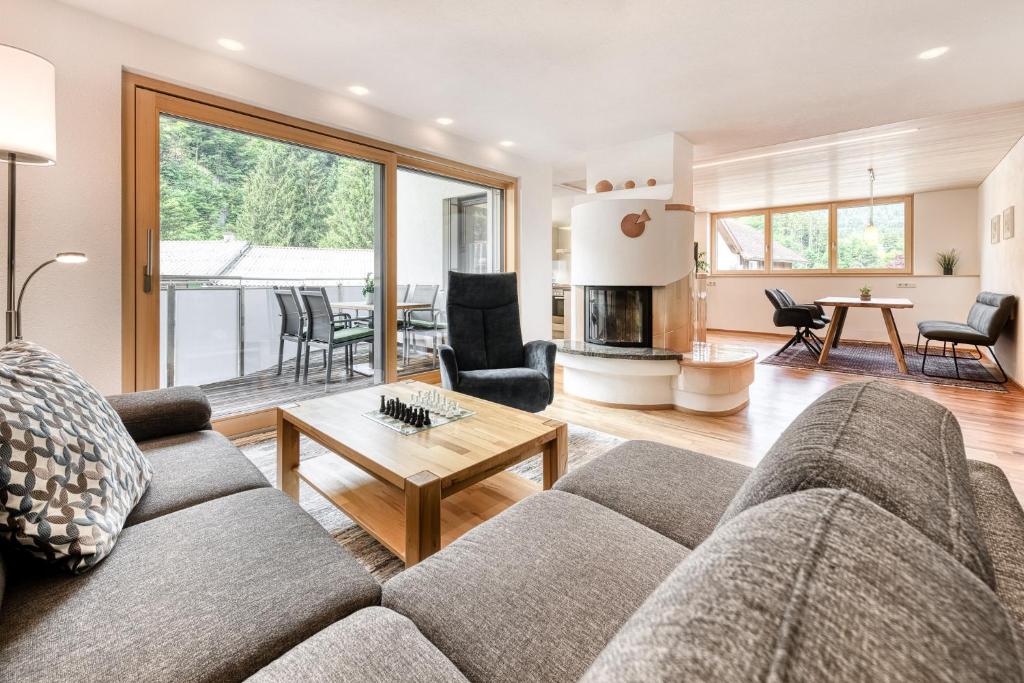 a living room with a couch and a table at Alpenferienwohnung in Bürs