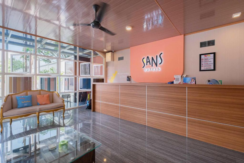a lobby with a sms office sign on the wall at Sans WM Hotel Blitar in Blitar