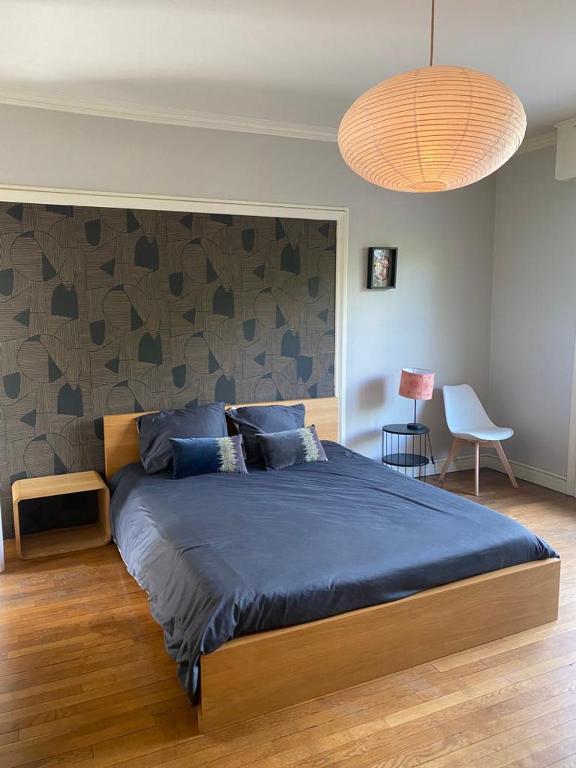 a bedroom with a large bed with a blue blanket at Hypercentral flat for 6 in Lorient in Lorient