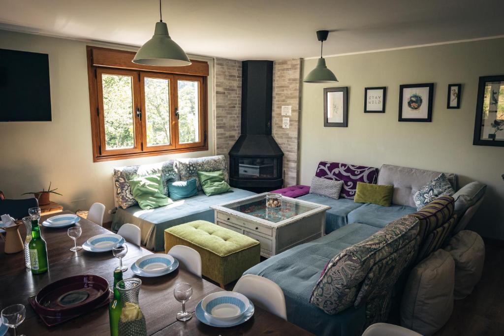 a living room with a couch and a table at Finca La Naguada Casa Rural en Asturias in Beloncio