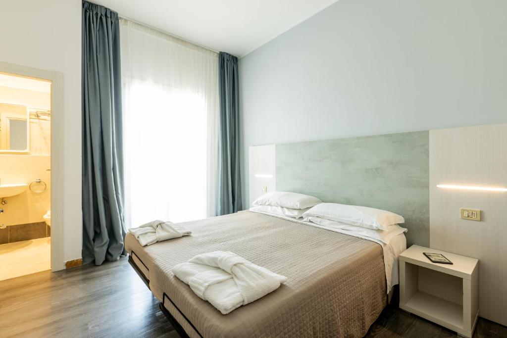 Postel nebo postele na pokoji v ubytování Hotel Kim