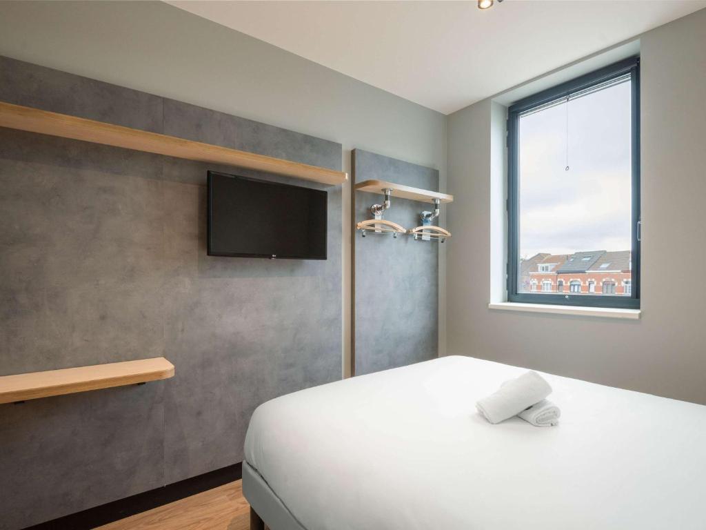 Postel nebo postele na pokoji v ubytování ibis budget Leuven Centrum