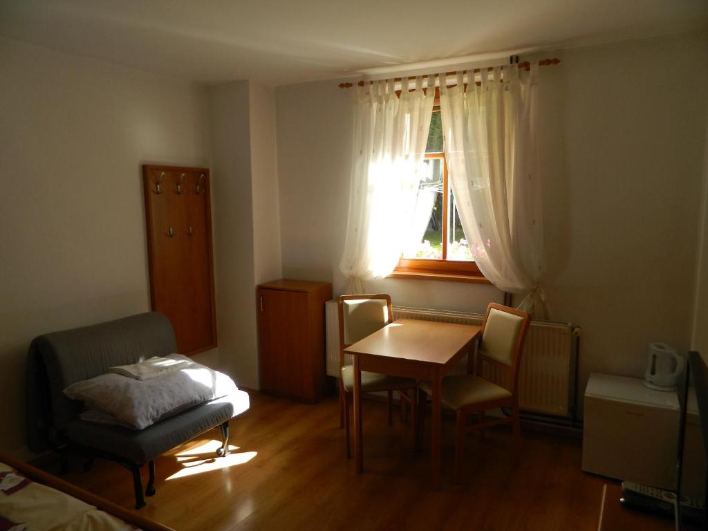 スピンドレルフ・ムリンにあるPrivát Fedoriškaのテーブルと椅子、窓が備わる小さな客室です。