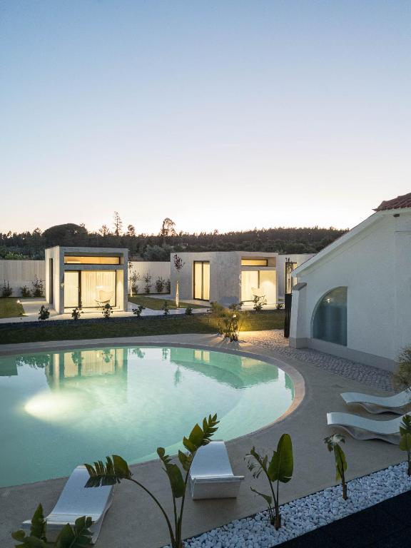 a swimming pool in the backyard of a house at L'École Eco Resort in Água Travessa
