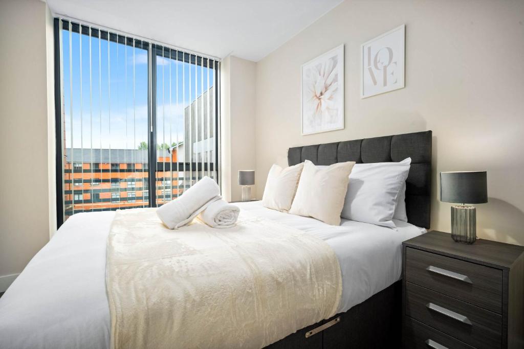 Hotel Stylish Two Bedroom Apartment - City Centre - Netflix - Wifi - Top Rated - JQ 8AH, a bedroom with a large white bed with a window at Stylish Two Bedroom Apartment - City Centre - Netflix - Wifi - Top Rated - JQ 8AH in Birmingham