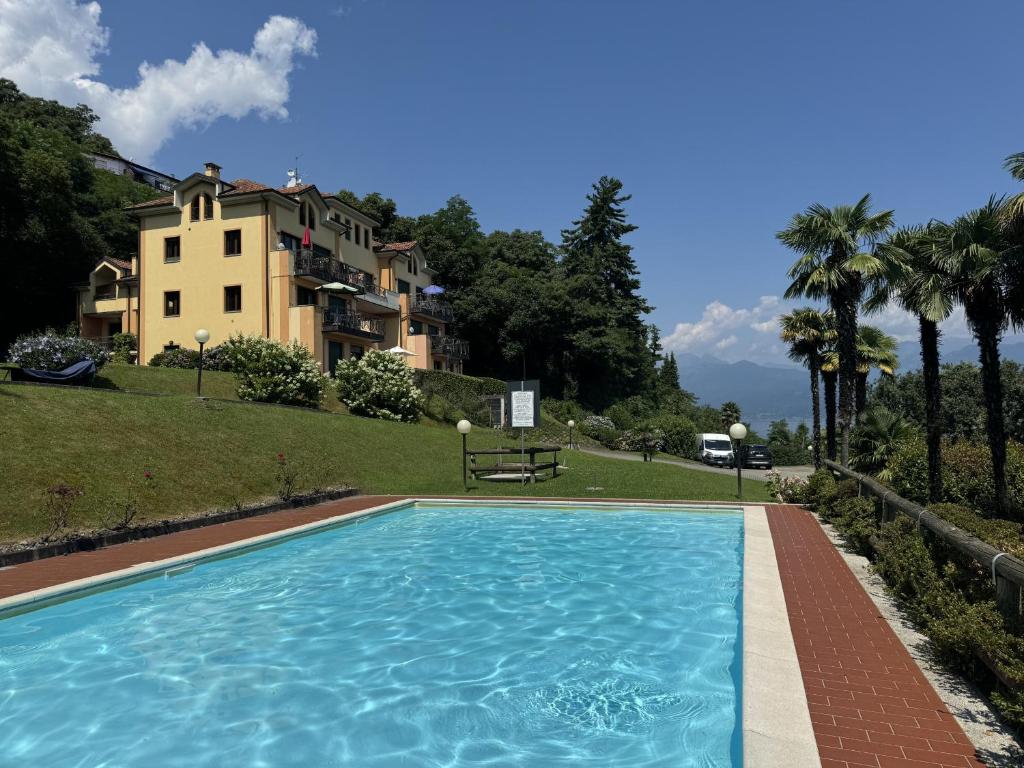 a large swimming pool in front of a house at Marta in Stresa