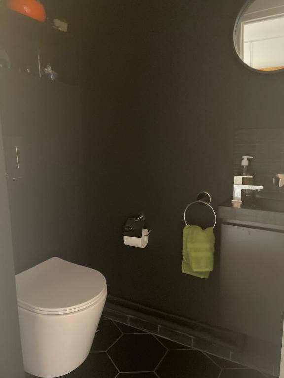 a bathroom with a white toilet and a sink at Panoramique vue NEW design proche Tour Eiffel in Paris