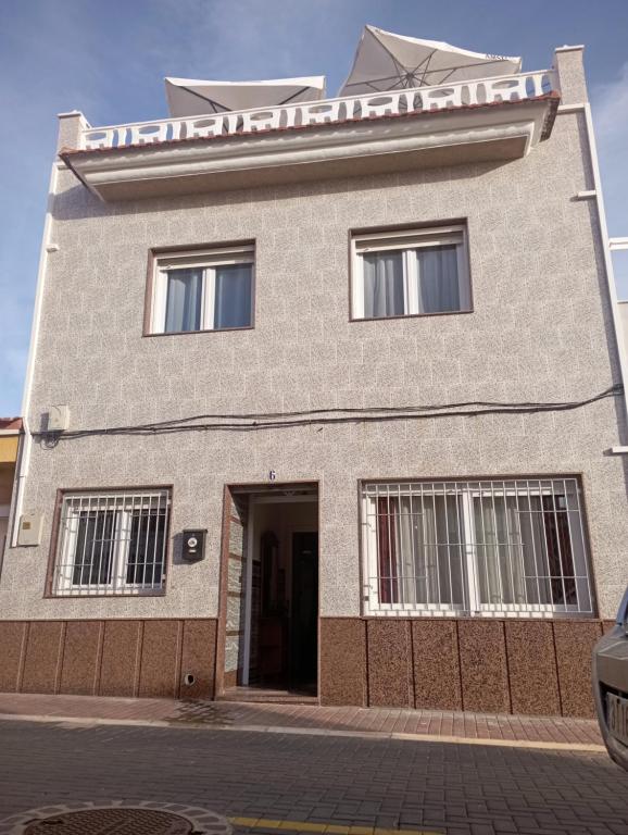 a large brick building with a front door at Mero Habitaciones in Cabo de Palos