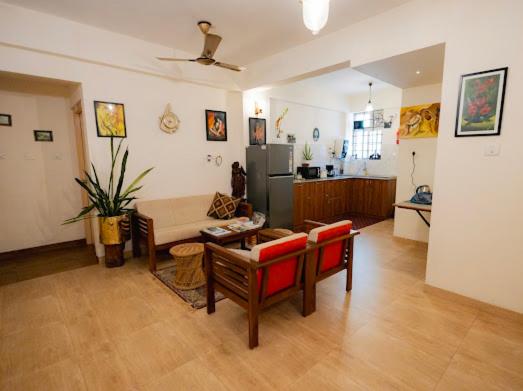 a living room with a couch and a table at La Lune Fort Kochi in Cochin