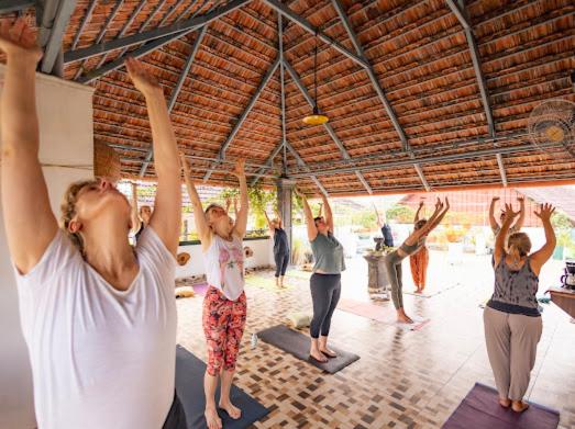 a group of people doing yoga in a gym at La Lune Fort Kochi in Cochin