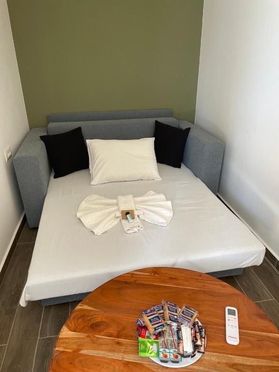 a bed in a room with a table at Elafonisi Paradise with Parking, WiFi, - Walking Distance to the Beach in Elafonisi
